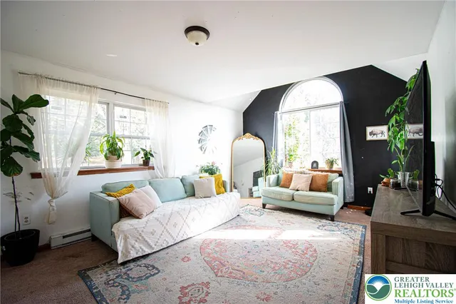 a living room with furniture and a large window