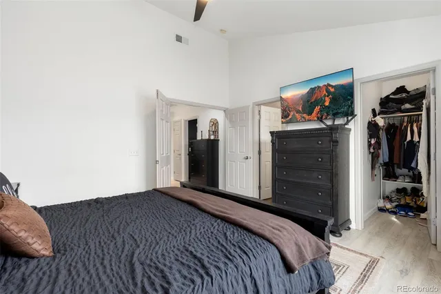 a bedroom with bed and walk in closet