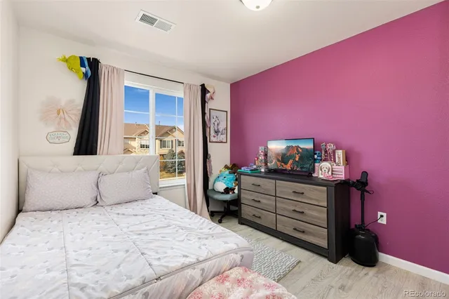 a bedroom with a bed and a dresser