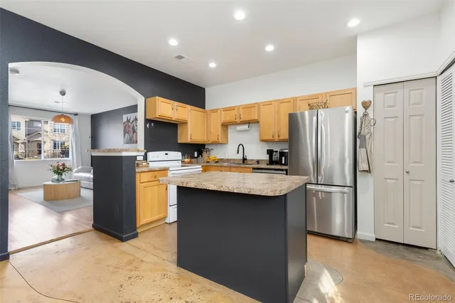 a kitchen with refrigerator and window