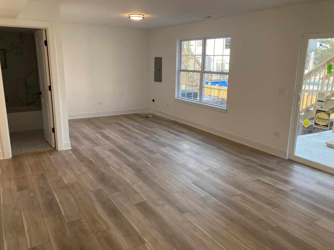 931 Saddle Ridge Drive Joliet, IL 60432 - Photo 18 of 23 an empty room with wooden floor and windows