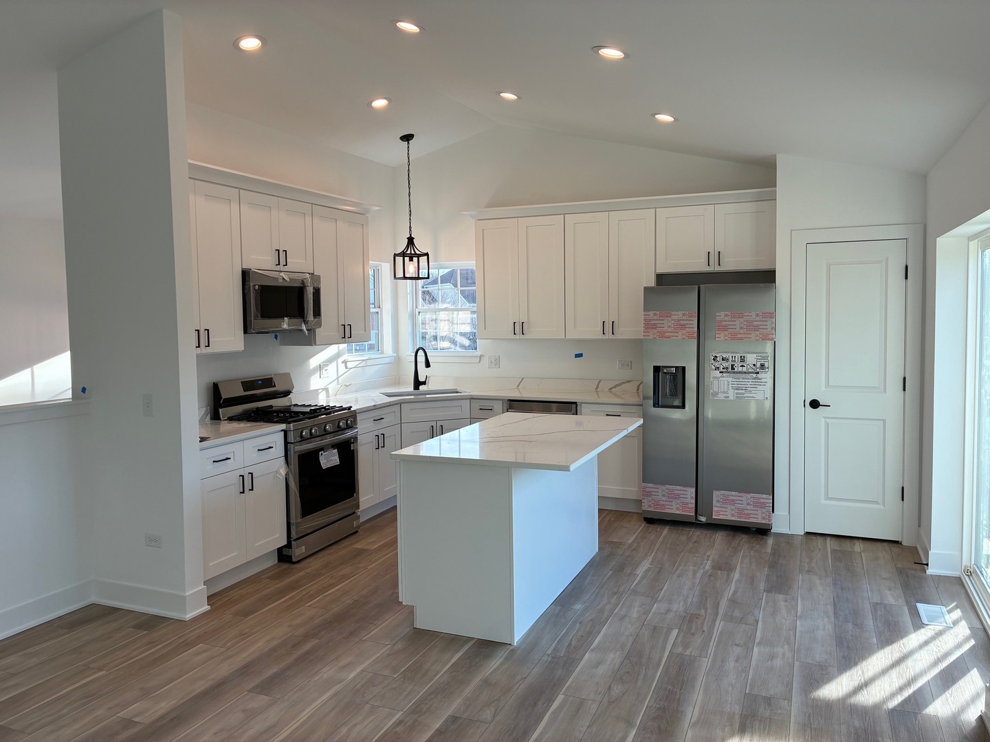 931 Saddle Ridge Drive Joliet, IL 60432 - Photo 4 of 23 a large kitchen with stainless steel appliances granite countertop a stove a sink and a refrigerator