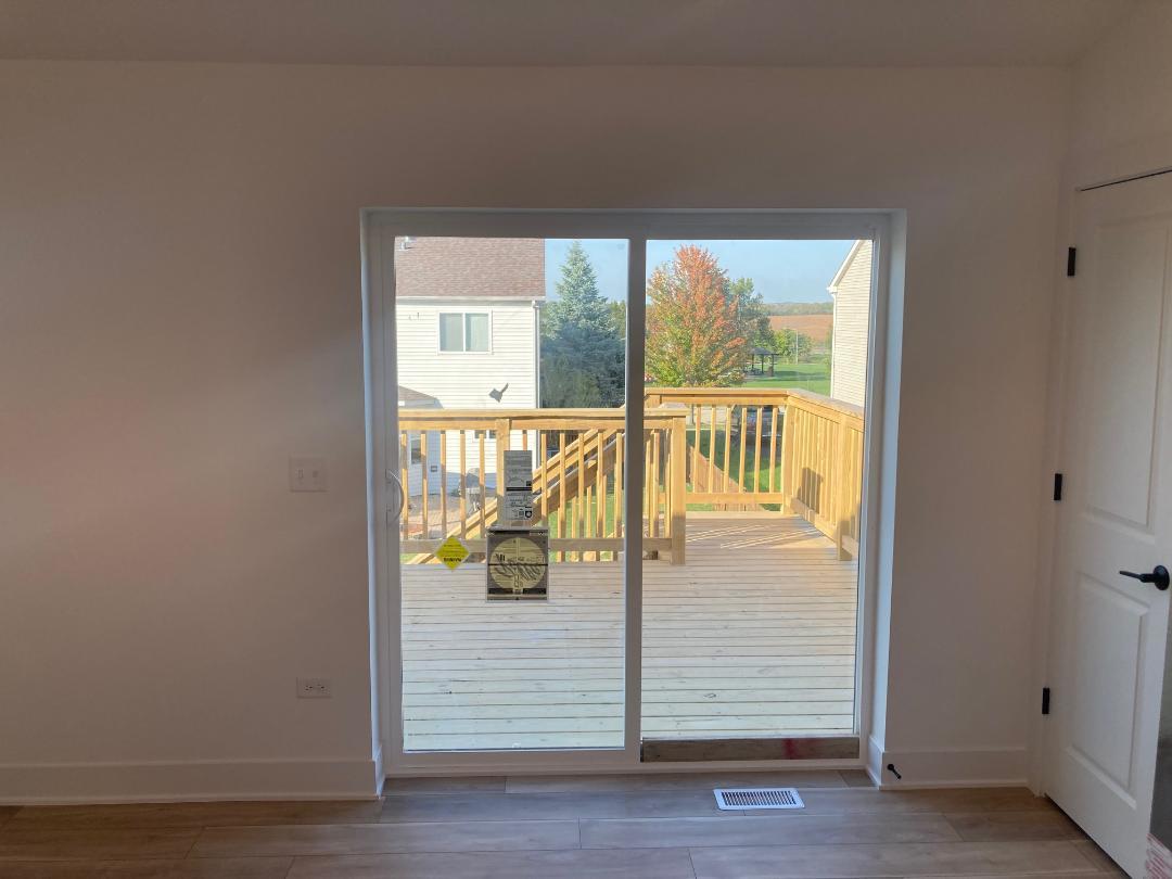 931 Saddle Ridge Drive Joliet, IL 60432 - Photo 6 of 23 an empty room with wooden floor and windows