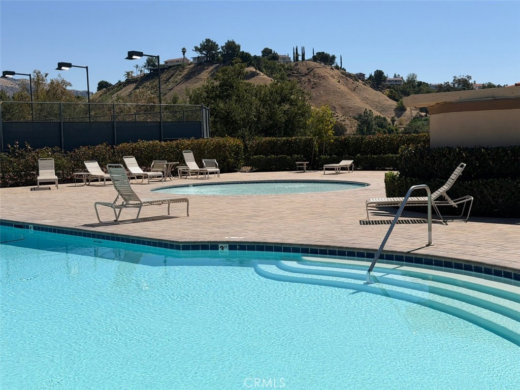 19823 Mariposa Pines Way Porter Ranch, CA 91326 - Photo 49 of 50 a view of a swimming pool with a lounge chair
