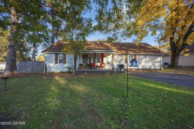 a front view of a house with a yard table and chairs