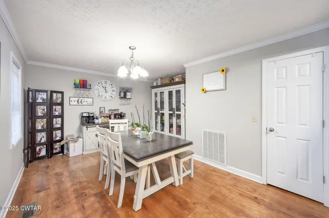 a dining room with furniture and wooden floor