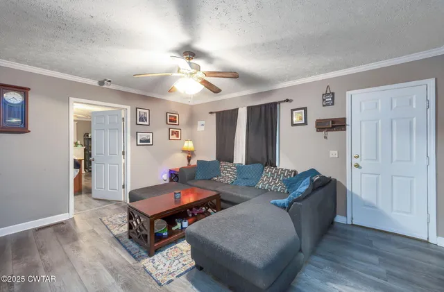 a living room with furniture and wooden floor