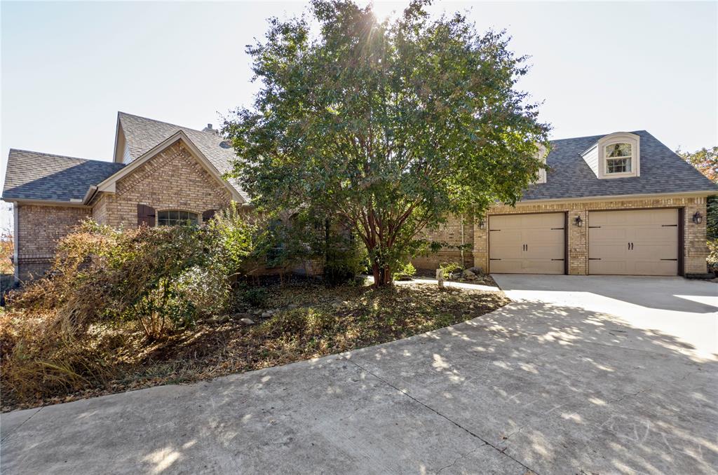 396 Ranchview Court Bowie, TX 76230 - Photo 36 of 38 a front view of a house with a yard and garage