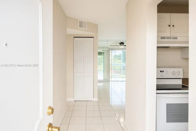 a view of kitchen with furniture and refrigerator