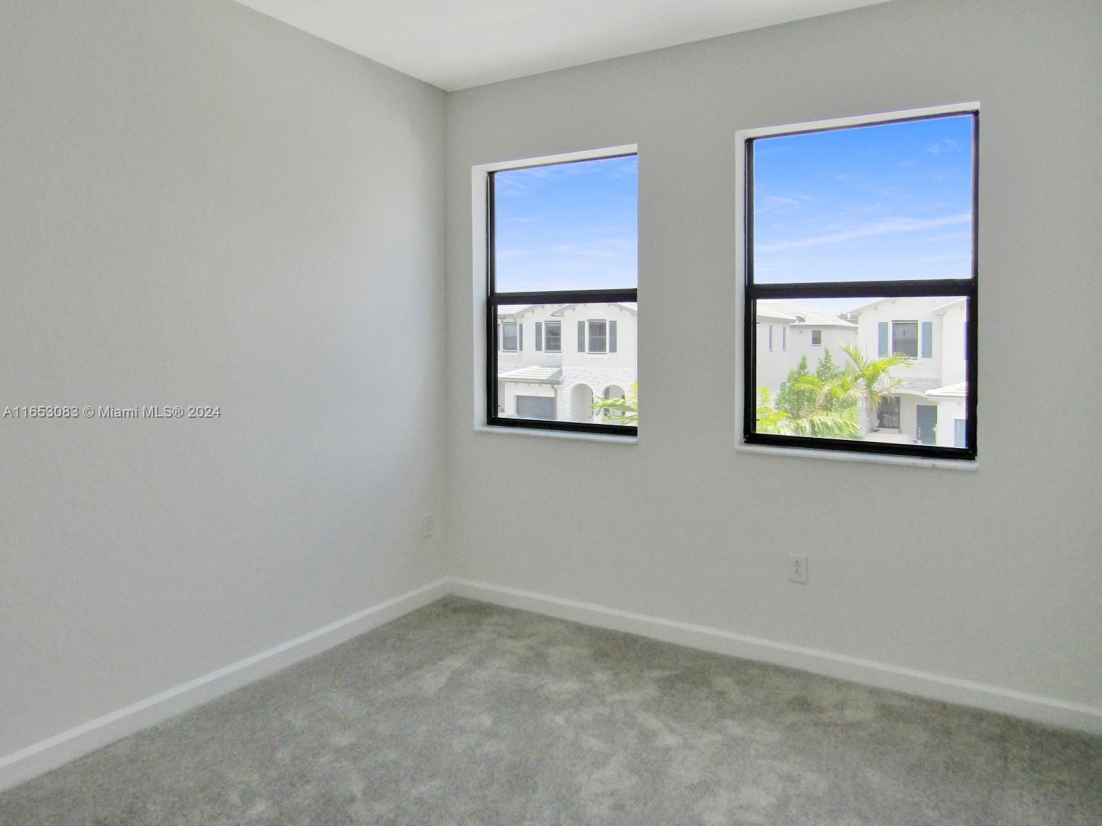 13401 Southwest 287th Street, Unit 13401 Homestead, FL 33033 - Photo 14 of 29 an empty room with windows