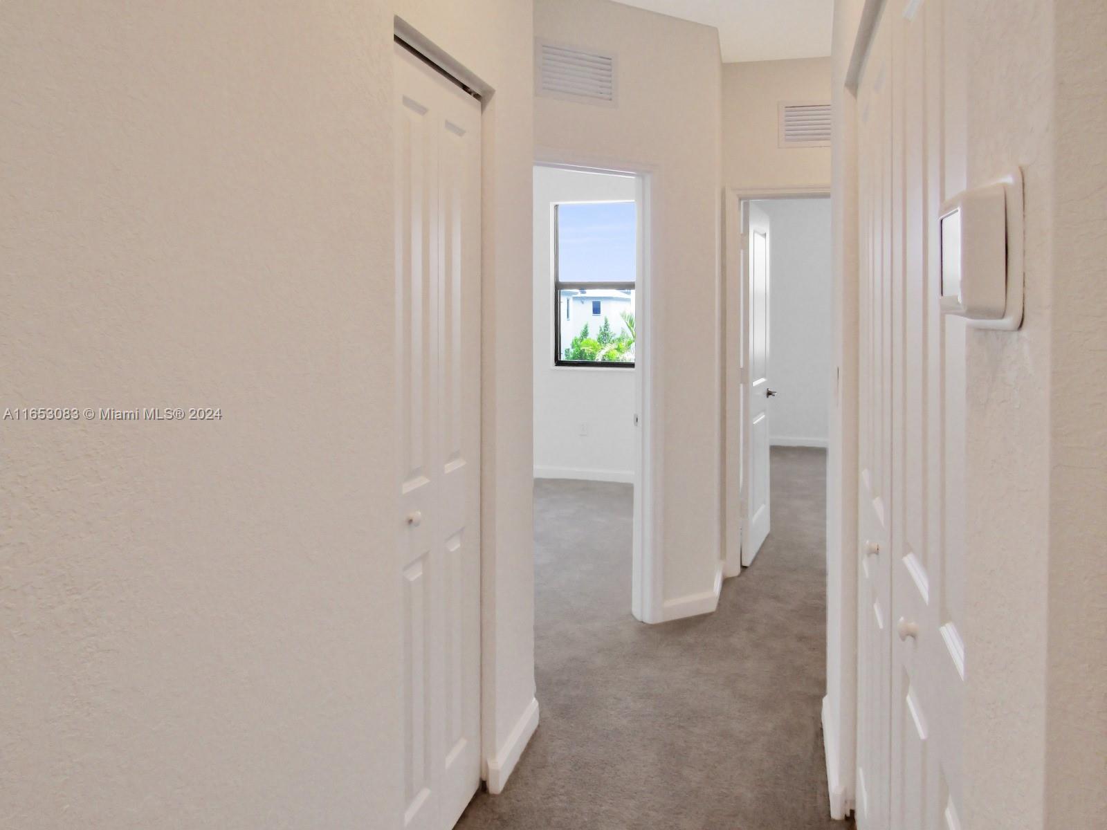 13401 Southwest 287th Street, Unit 13401 Homestead, FL 33033 - Photo 20 of 29 a view of a hallway with wooden floor