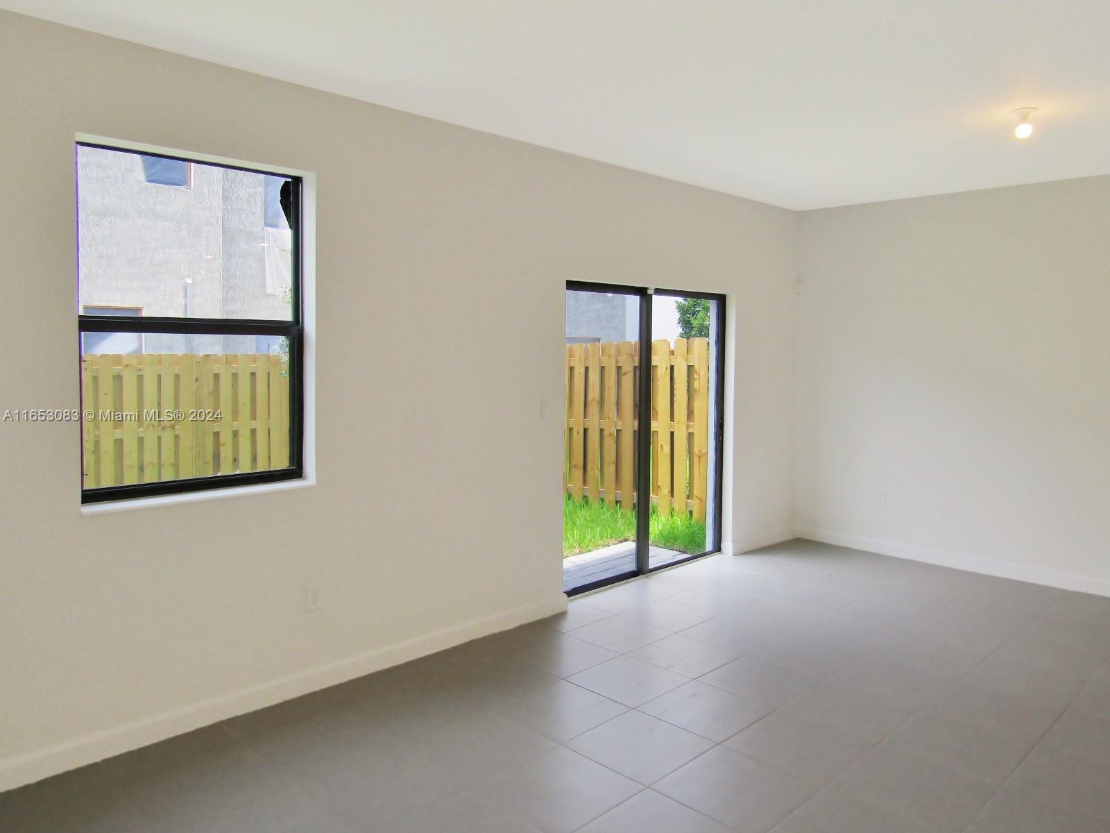 13401 Southwest 287th Street, Unit 13401 Homestead, FL 33033 - Photo 21 of 29 an empty room with windows