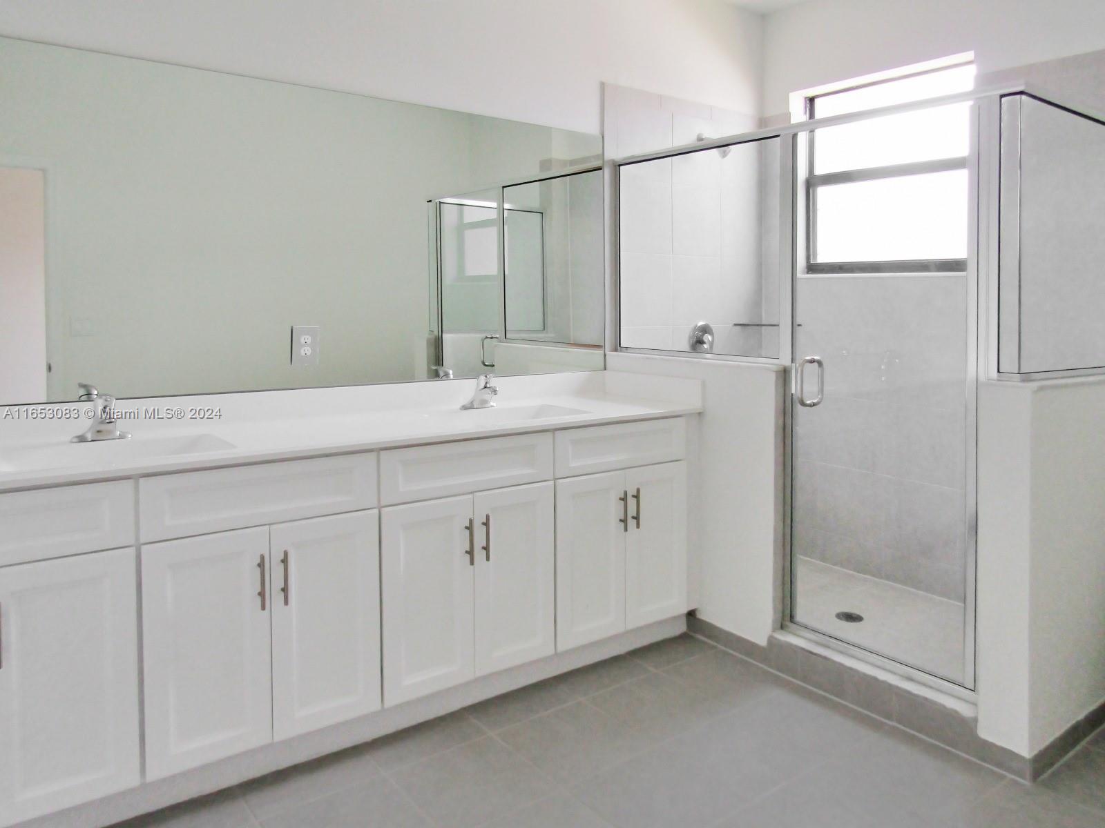 13401 Southwest 287th Street, Unit 13401 Homestead, FL 33033 - Photo 26 of 29 a bathroom with a double vanity sink and mirror