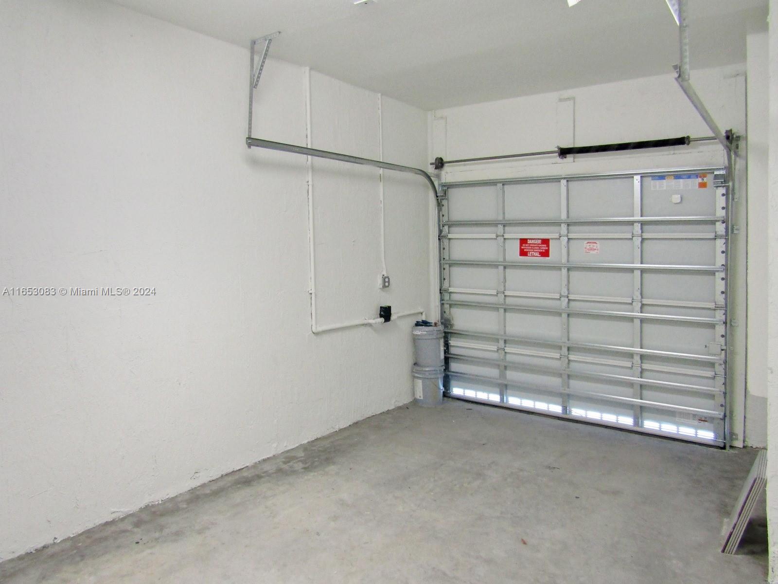 13401 Southwest 287th Street, Unit 13401 Homestead, FL 33033 - Photo 27 of 29 a view of a garage