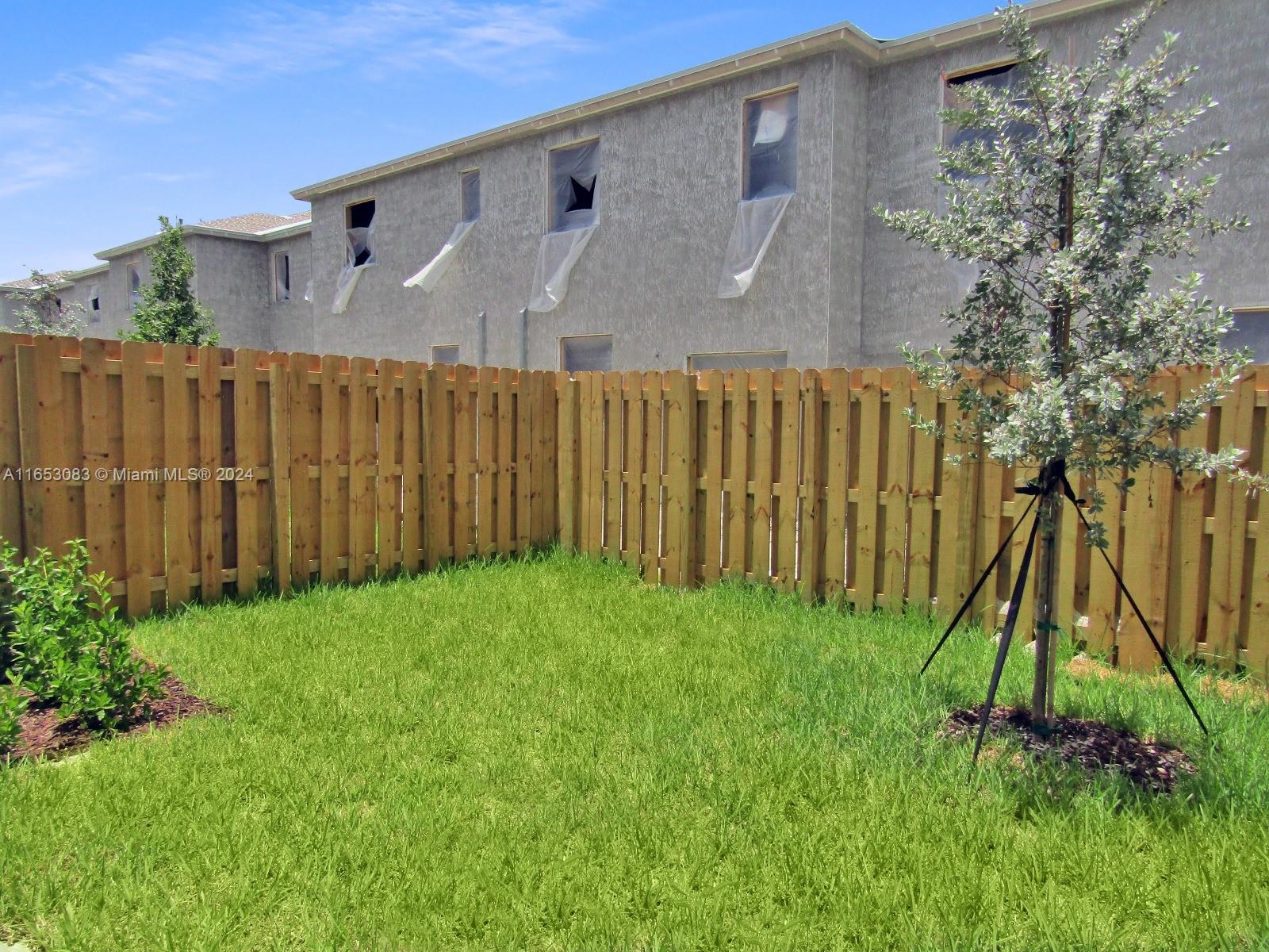13401 Southwest 287th Street, Unit 13401 Homestead, FL 33033 - Photo 29 of 29 a backyard of a house with lots of green space