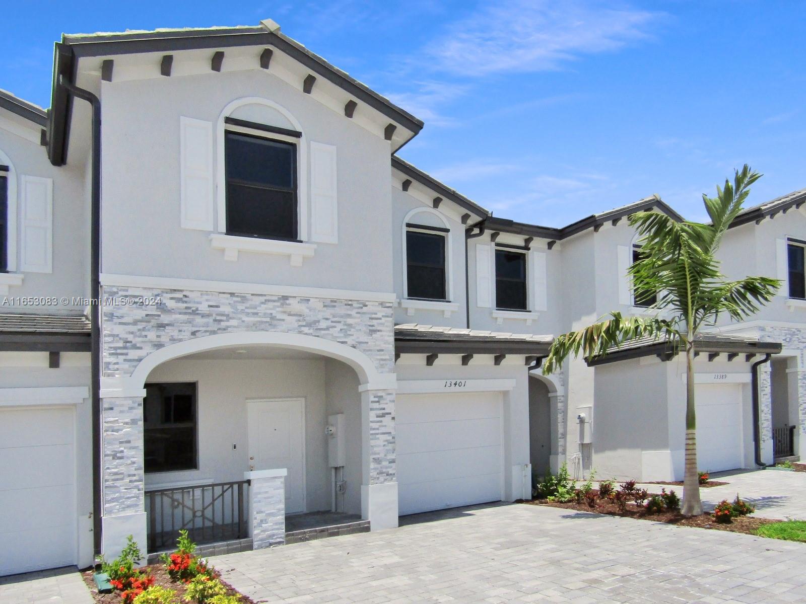13401 Southwest 287th Street, Unit 13401 Homestead, FL 33033 - Photo 3 of 29 a front view of a house with garden