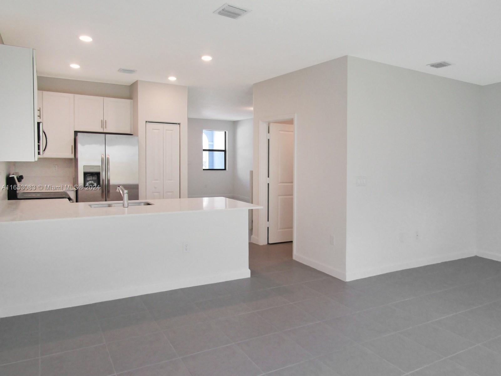 13401 Southwest 287th Street, Unit 13401 Homestead, FL 33033 - Photo 5 of 29 a bathroom with a sink a mirror and a toilet