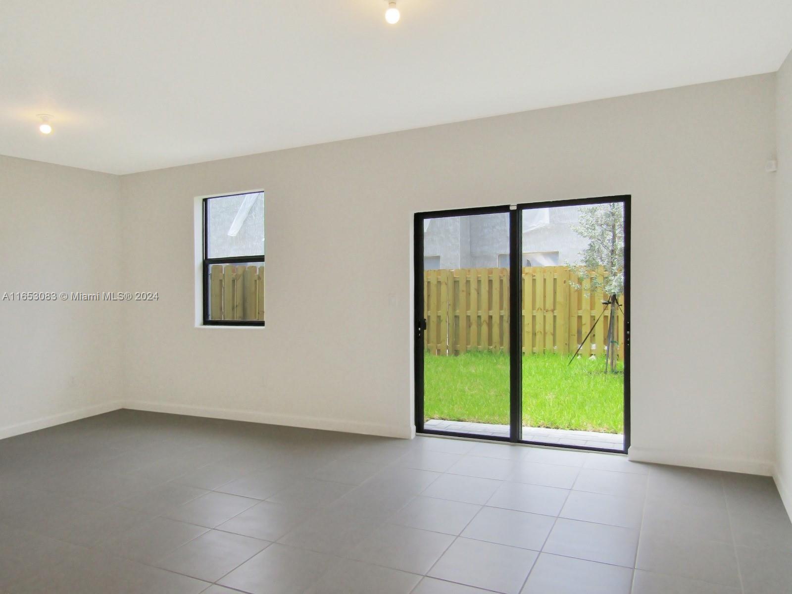 13401 Southwest 287th Street, Unit 13401 Homestead, FL 33033 - Photo 9 of 29 a view of an empty room with a window