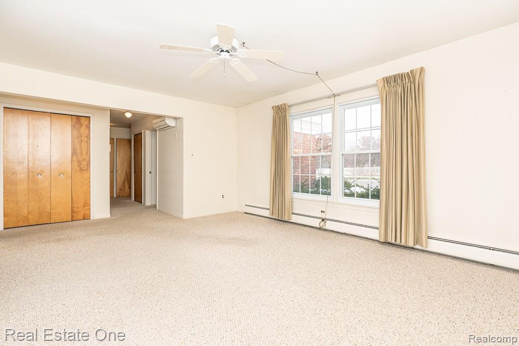 28777 West 11 Mile Road Farmington, MI 48336 - Photo 8 of 53 Living featuring carpet flooring, ceiling fan, a closet, and a wall unit AC