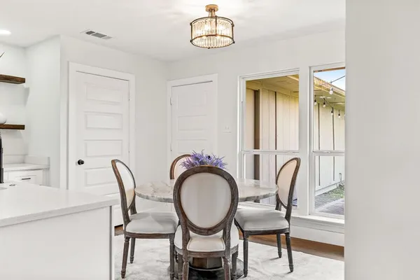a view of a room with furniture and wooden floor