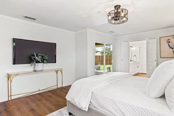 a bedroom with a bed and a chandelier