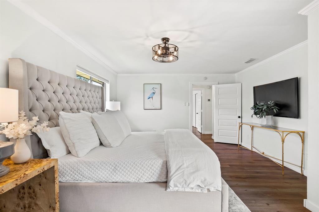 2205 Timberwood Carrollton, TX 75006 - Photo 15 of 32 a bedroom with a bed and a flat screen tv