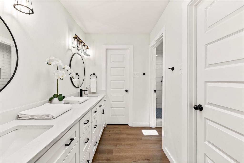 2205 Timberwood Carrollton, TX 75006 - Photo 16 of 32 a bathroom with a double vanity sink and a mirror