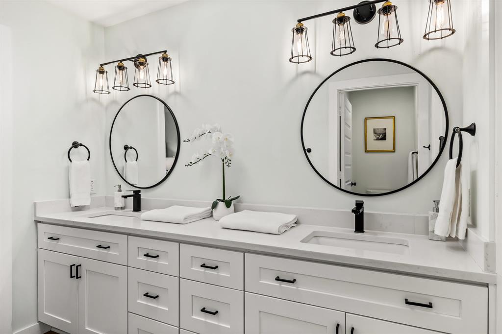 2205 Timberwood Carrollton, TX 75006 - Photo 17 of 32 a bathroom with a sink and a mirror