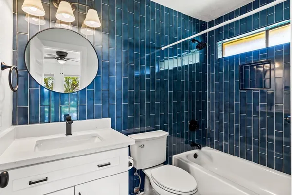 a bathroom with a sink a toilet and a mirror