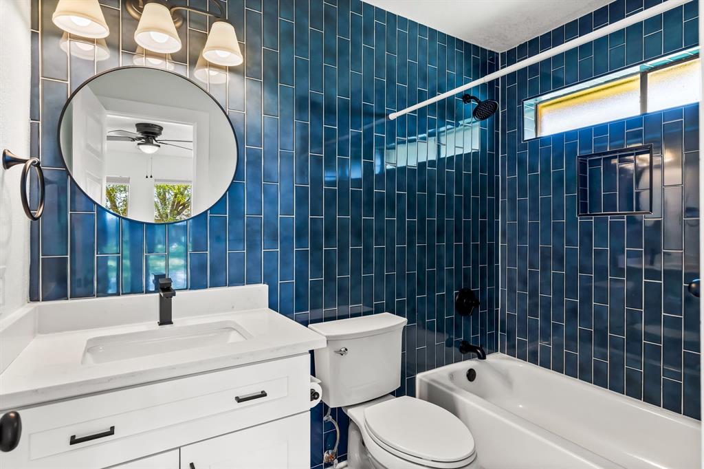 2205 Timberwood Carrollton, TX 75006 - Photo 20 of 32 a bathroom with a sink a toilet and a mirror