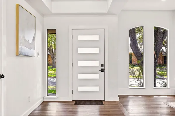 a view of an entryway with wooden floor