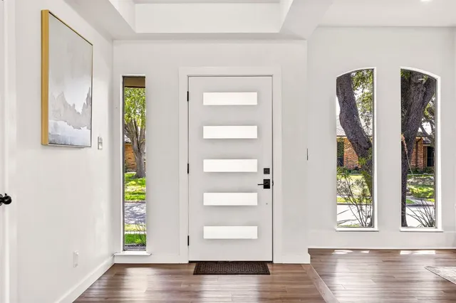 a view of an entryway with wooden floor