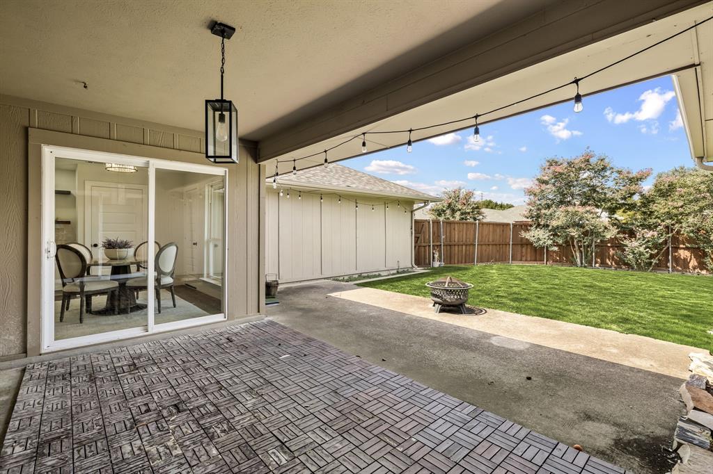 2205 Timberwood Carrollton, TX 75006 - Photo 24 of 32 a patio with table and chairs