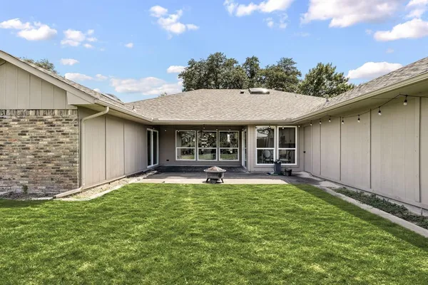 a view of a house with backyard porch and sitting area