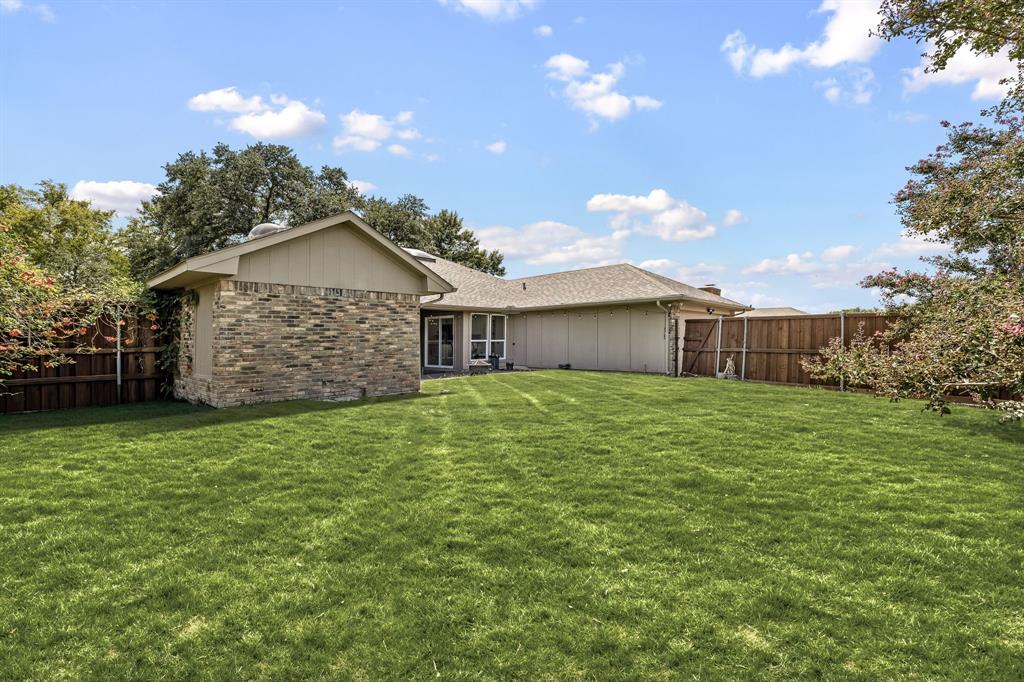 2205 Timberwood Carrollton, TX 75006 - Photo 26 of 32 a front view of a house with a garden