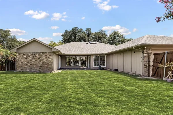 a view of a house with a yard and sitting area