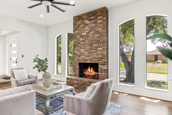 a living room with furniture a chandelier and a fireplace