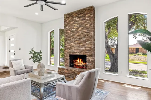a living room with furniture a chandelier and a fireplace