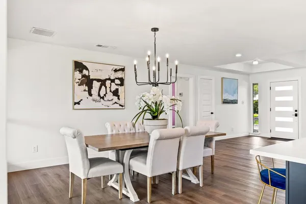 a view of a dining room with furniture wooden floor and chandelier