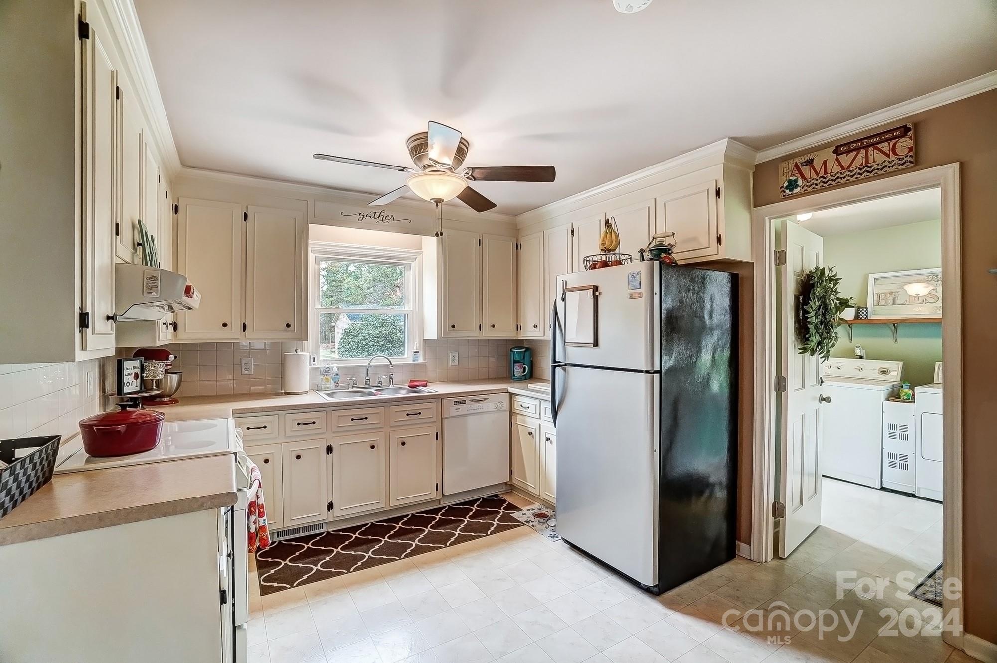 2803 Trinity Church Road Monroe, NC 28112 - Photo 14 of 48 a kitchen with stainless steel appliances a refrigerator sink and cabinets