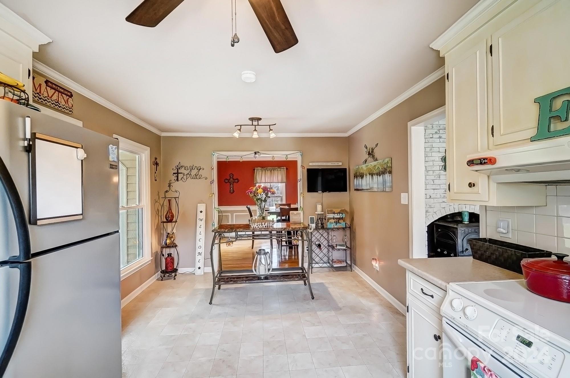 2803 Trinity Church Road Monroe, NC 28112 - Photo 15 of 48 a kitchen with stainless steel appliances kitchen island granite countertop a refrigerator and a stove top oven