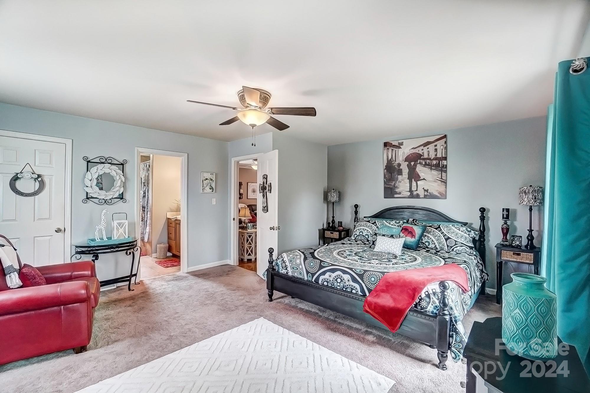 2803 Trinity Church Road Monroe, NC 28112 - Photo 22 of 48 a bedroom with furniture and a chandelier