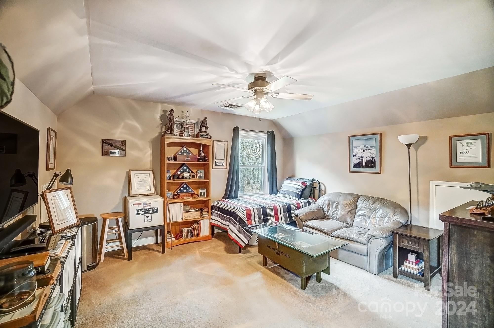 2803 Trinity Church Road Monroe, NC 28112 - Photo 27 of 48 a bedroom with furniture and a flat screen tv