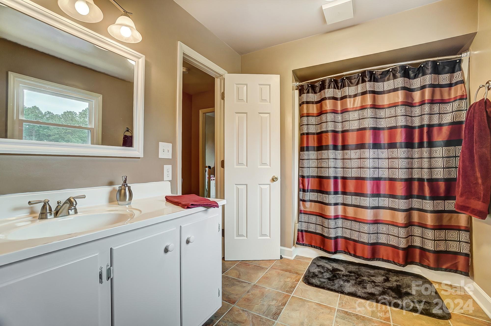 2803 Trinity Church Road Monroe, NC 28112 - Photo 31 of 48 a bathroom with a sink and a mirror