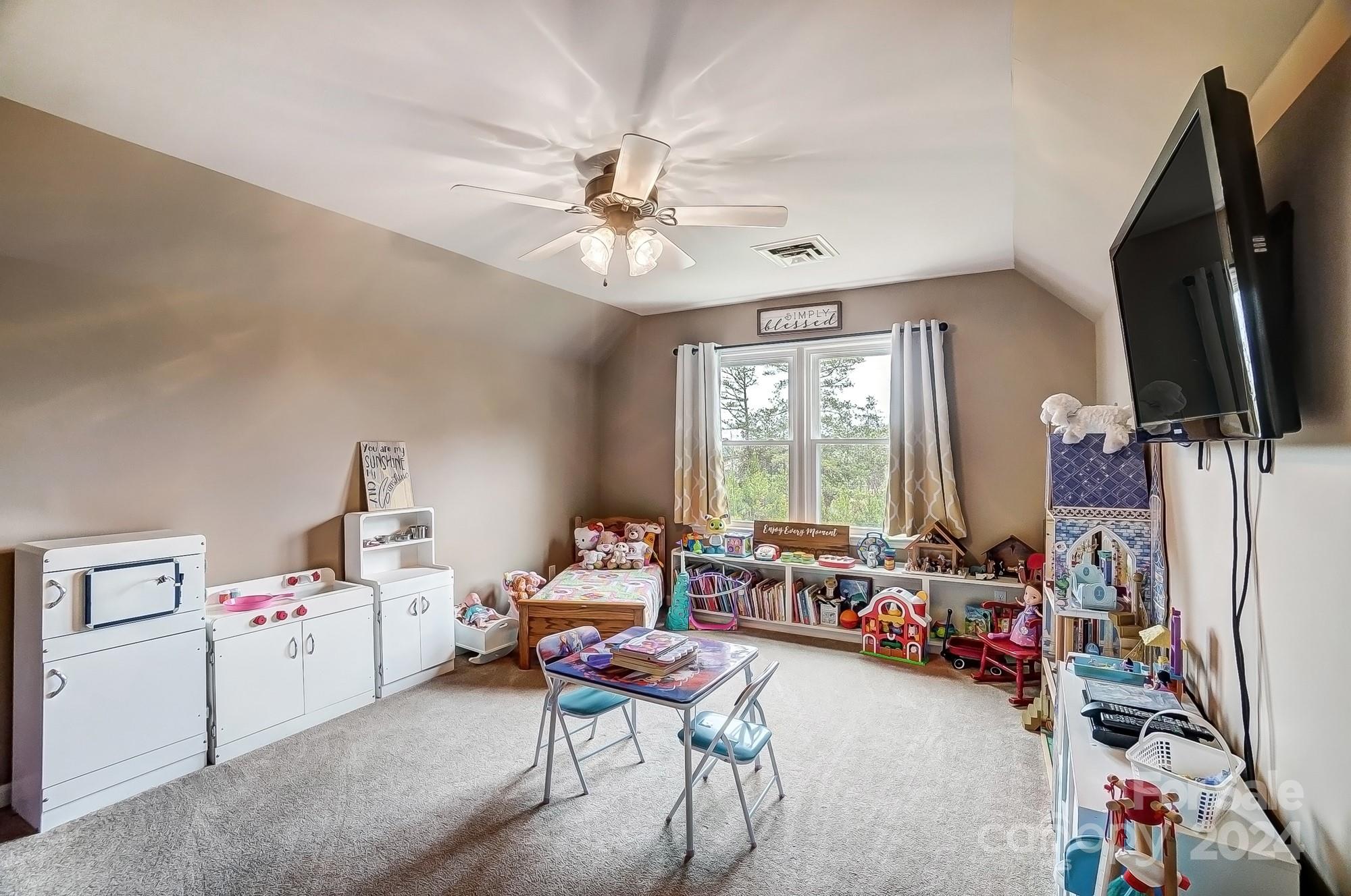 2803 Trinity Church Road Monroe, NC 28112 - Photo 34 of 48 a living room with furniture a flat screen tv and a window