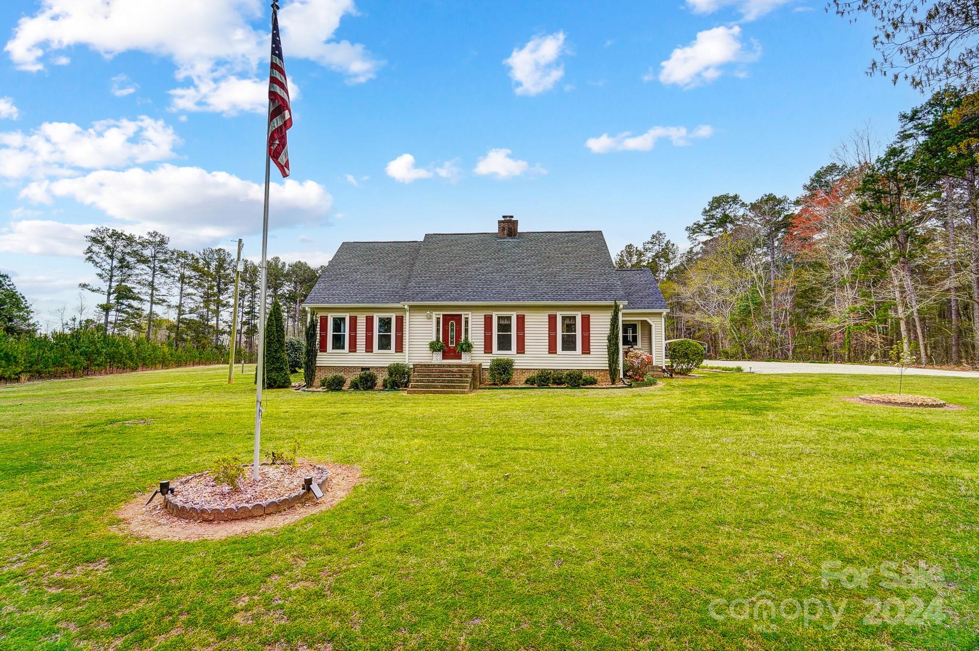 2803 Trinity Church Road Monroe, NC 28112 - Photo 6 of 48 a front view of a house with a garden