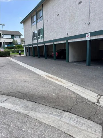a view of a cars park in front of a building