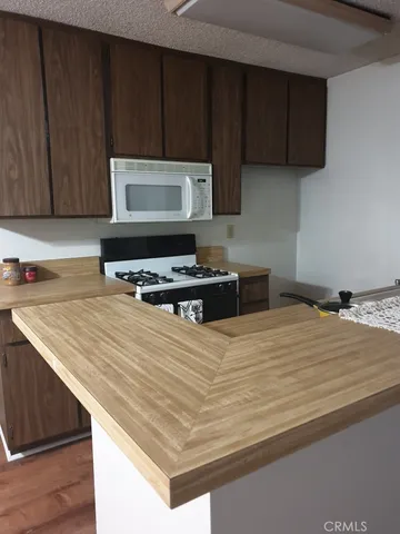 a kitchen with wooden cabinets and a sink
