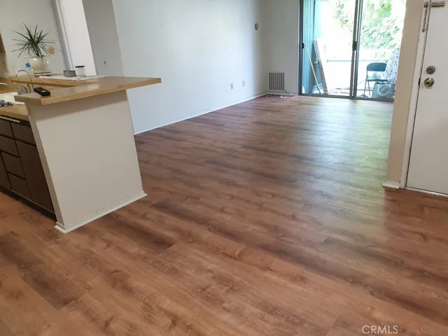 a view of a room with wooden floor