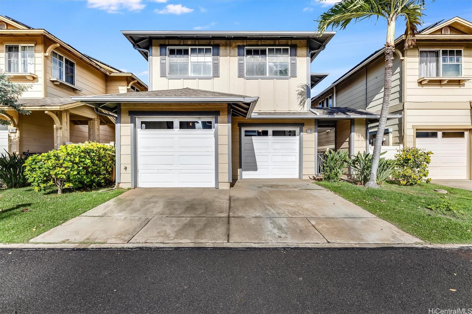 91-3091 Makalea Loop Ewa Beach, HI 96706 - Photo 1 of 1 a front view of a house with a yard and garage